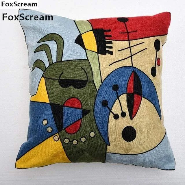 Housse de coussin brodée géométrique